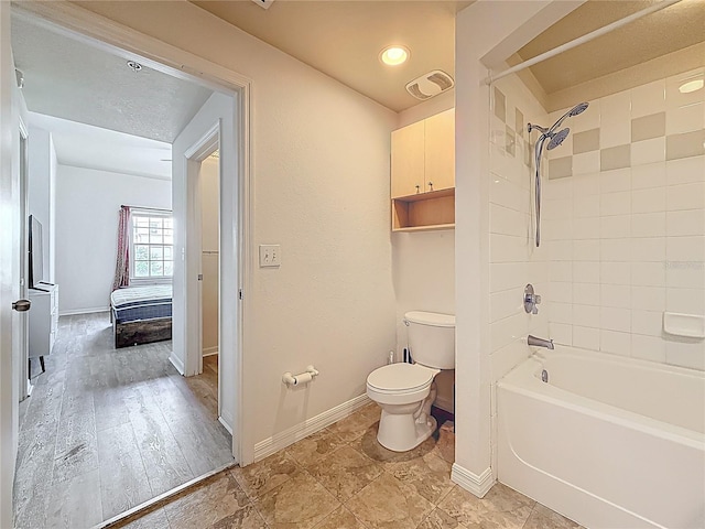 200 4th Ave S Unit 229, Saint Petersburg, FL 33701 - full bathroom featuring baseboards, toilet, and shower / washtub combination