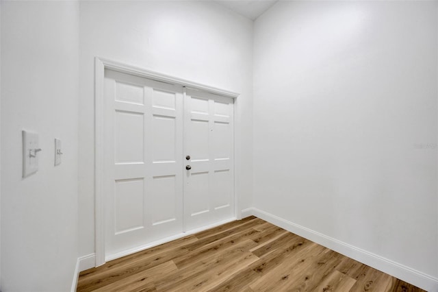 foyer entrance with light wood finished floors and baseboards