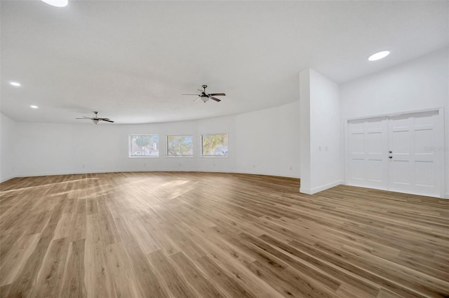 unfurnished living room with light wood finished floors, baseboards, a ceiling fan, and recessed lighting