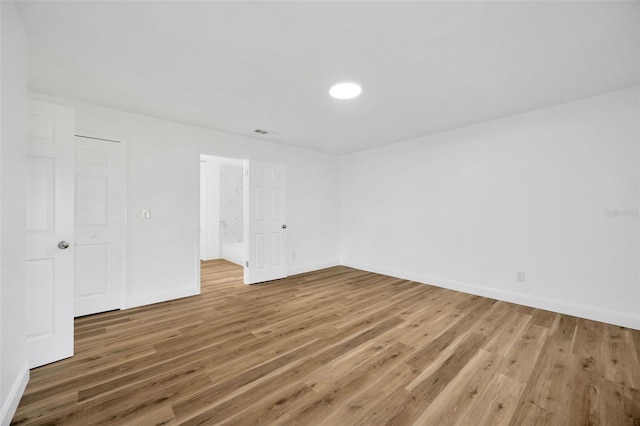 unfurnished bedroom featuring wood finished floors and baseboards