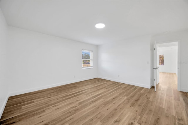unfurnished room featuring light wood-style floors and baseboards