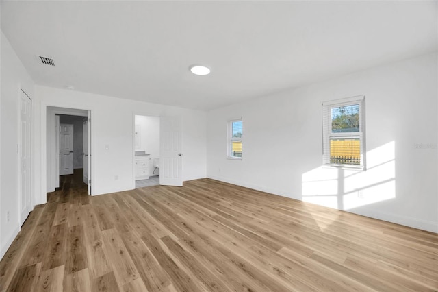unfurnished living room with light wood-style flooring and baseboards