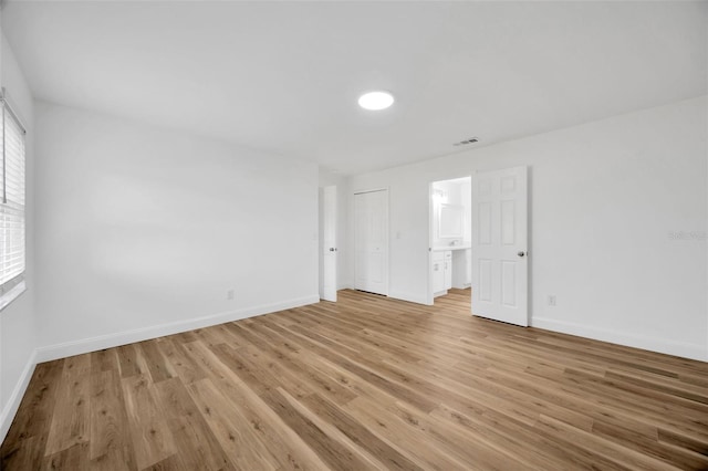 unfurnished bedroom featuring baseboards and light wood-type flooring