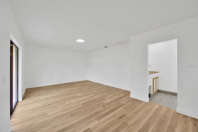 spare room with light wood finished floors, baseboards, and recessed lighting