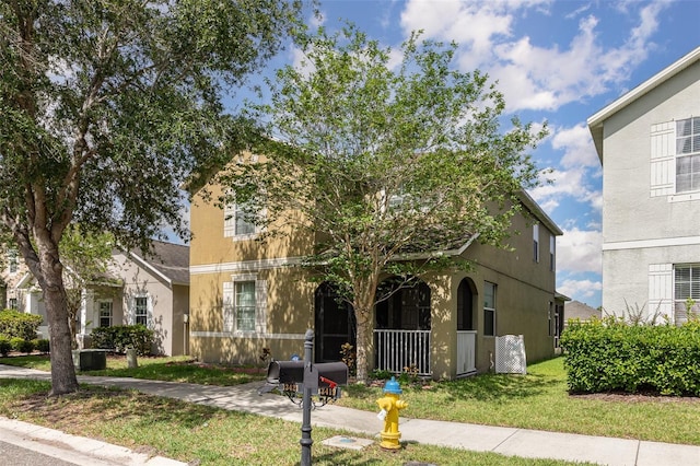 13421 Lake Monroe Pl, Riverview, FL 33579 - view of front of property featuring stucco siding, a front lawn, and covered porch