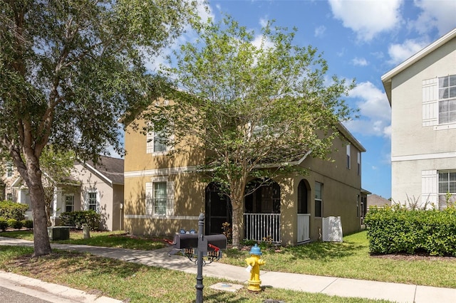 13421 Lake Monroe Pl, Riverview, FL 33579 - view of front of house with a front yard, stucco siding, and covered porch