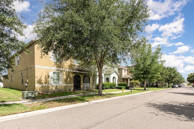 13421 Lake Monroe Pl, Riverview, FL 33579 - view of property hidden behind natural elements with stucco siding and central air condition unit