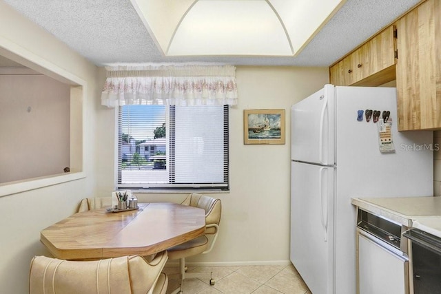 172 Lakeview Way Unit 172, Oldsmar, FL 34677 - kitchen featuring baseboards, light countertops, light tile patterned flooring, and freestanding refrigerator
