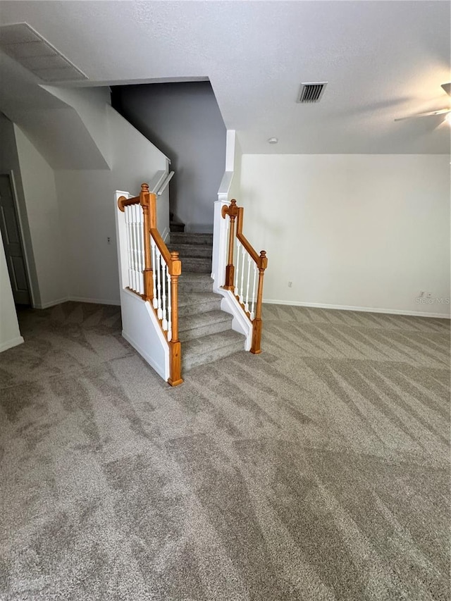 stairway with carpet floors, baseboards, and ceiling fan