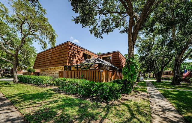 2706 11th Ct, Palm Harbor, FL 34684 - view of home's exterior featuring brick siding, mansard roof, and a yard