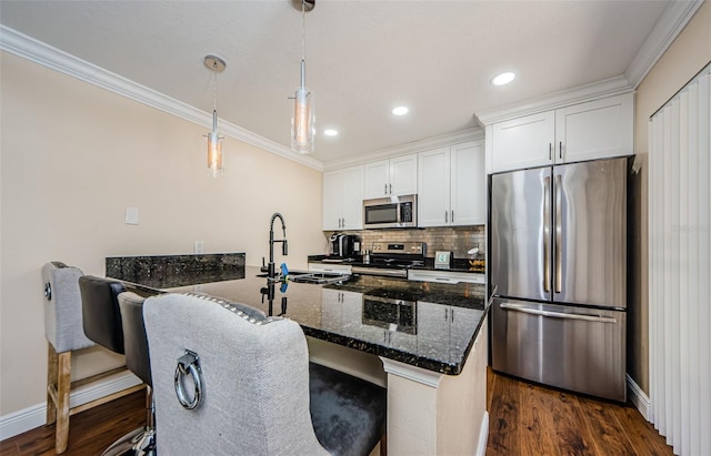 2706 11th Ct, Palm Harbor, FL 34684 - kitchen with stainless steel appliances, crown molding, backsplash, dark wood-style floors, and dark stone countertops