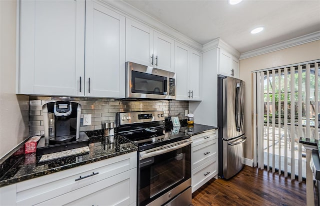 2706 11th Ct, Palm Harbor, FL 34684 - kitchen featuring stainless steel appliances, crown molding, backsplash, white cabinetry, and dark stone countertops