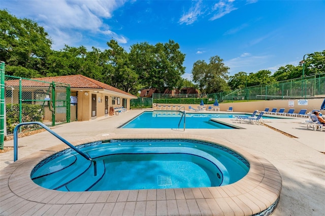 2706 11th Ct, Palm Harbor, FL 34684 - community pool with a hot tub, a patio area, and view of wooded area