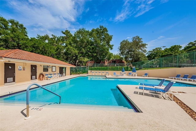 2706 11th Ct, Palm Harbor, FL 34684 - community pool featuring a patio area and view of scattered trees