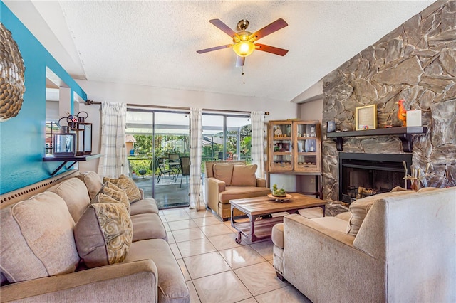 1024 Dockside Dr, Lutz, FL 33559 - living area featuring a textured ceiling, ceiling fan, vaulted ceiling, a stone fireplace, and tile patterned floors