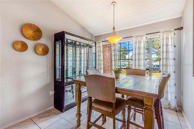 1024 Dockside Dr, Lutz, FL 33559 - dining room featuring a textured ceiling, baseboards, lofted ceiling, and light tile patterned flooring