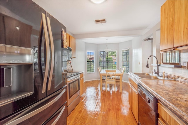 1024 Dockside Dr, Lutz, FL 33559 - kitchen with fridge with ice dispenser, a sink, stainless steel range with electric cooktop, dishwasher, and light wood finished floors