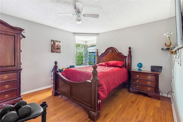 1024 Dockside Dr, Lutz, FL 33559 - bedroom with light wood-type flooring, a textured ceiling, baseboards, and ceiling fan
