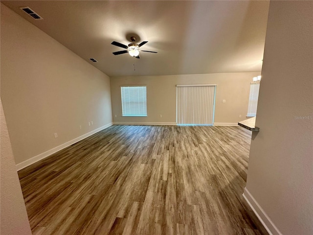 1259 Groveland Ln, Lakeland, FL 33811 - unfurnished living room featuring baseboards and wood finished floors