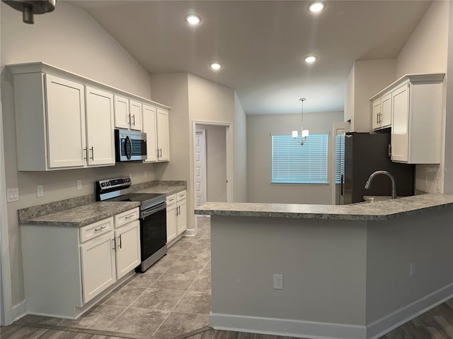 1259 Groveland Ln, Lakeland, FL 33811 - kitchen featuring stainless steel appliances, a peninsula, white cabinets, recessed lighting, and hanging light fixtures