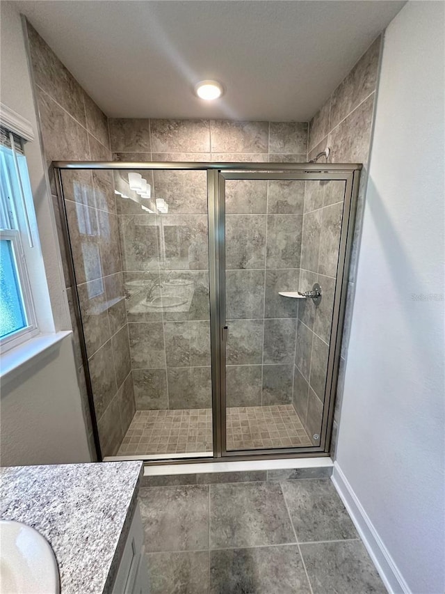 1259 Groveland Ln, Lakeland, FL 33811 - bathroom with a stall shower, baseboards, and vanity