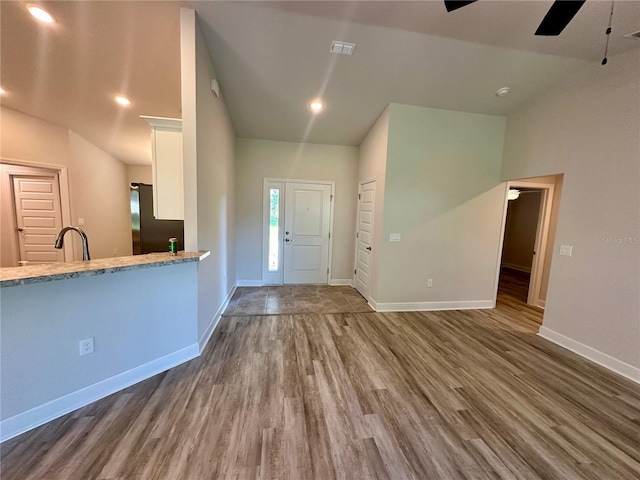 1259 Groveland Ln, Lakeland, FL 33811 - foyer entrance with ceiling fan, wood finished floors, baseboards, lofted ceiling, and recessed lighting