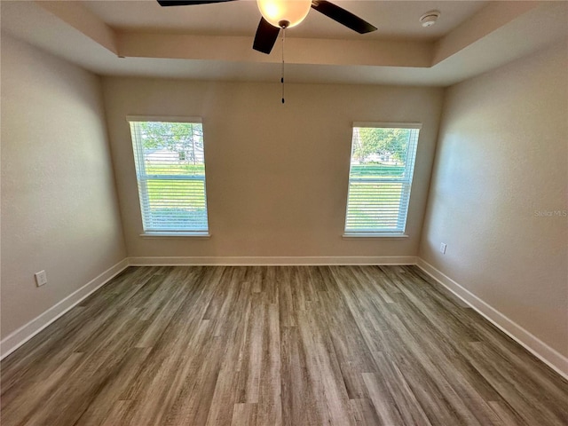 1259 Groveland Ln, Lakeland, FL 33811 - empty room with wood finished floors, plenty of natural light, and a smoke detector