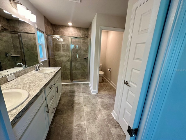 1259 Groveland Ln, Lakeland, FL 33811 - full bathroom featuring a shower stall, toilet, double vanity, and baseboards