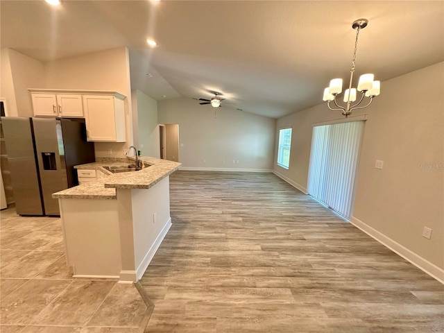 1259 Groveland Ln, Lakeland, FL 33811 - kitchen with a sink, stainless steel refrigerator with ice dispenser, a peninsula, ceiling fan, and vaulted ceiling