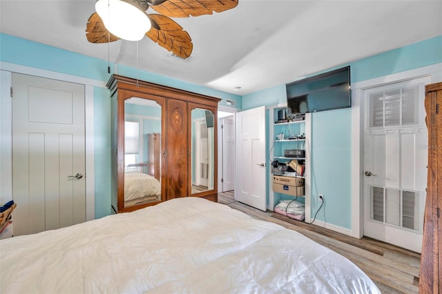 8931 Blind Pass Rd Unit 360, St Pete Beach, FL 33706 - bedroom featuring wood finished floors, french doors, and ceiling fan
