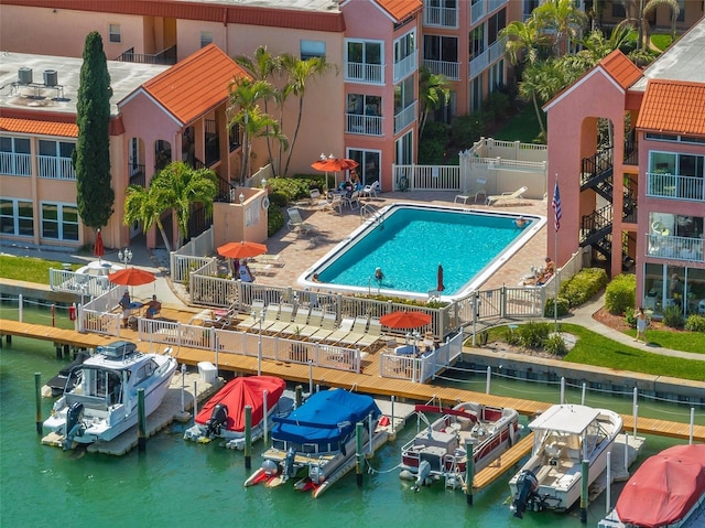 8931 Blind Pass Rd Unit 360, St Pete Beach, FL 33706 - community pool featuring fence, a dock, a water view, and boat lift