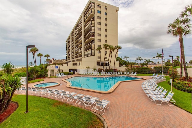 14950 Gulf Blvd Unit 603, Madeira Beach, FL 33708 - community pool featuring a hot tub, a patio, and a yard