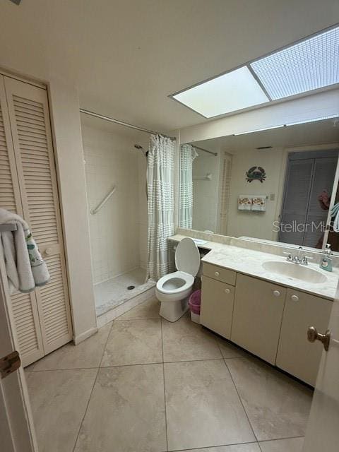 14950 Gulf Blvd Unit 603, Madeira Beach, FL 33708 - bathroom with a skylight, a shower stall, tile patterned floors, vanity, and toilet
