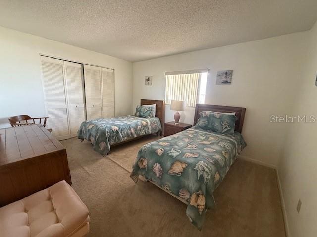 14950 Gulf Blvd Unit 603, Madeira Beach, FL 33708 - bedroom with carpet, a closet, and a textured ceiling