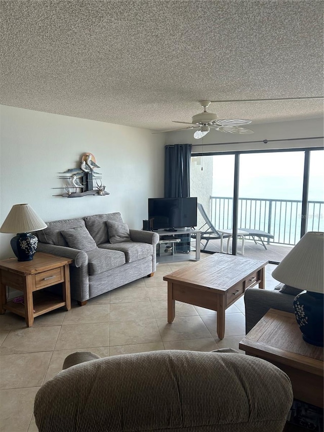 14950 Gulf Blvd Unit 603, Madeira Beach, FL 33708 - living room featuring ceiling fan, a textured ceiling, and light tile patterned floors