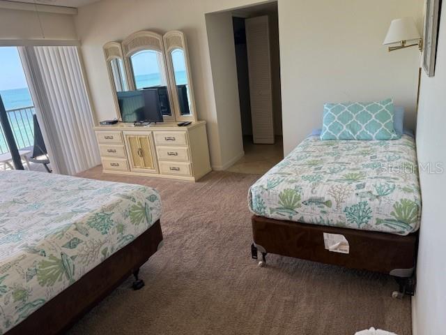 14950 Gulf Blvd Unit 603, Madeira Beach, FL 33708 - bedroom with light carpet and multiple windows