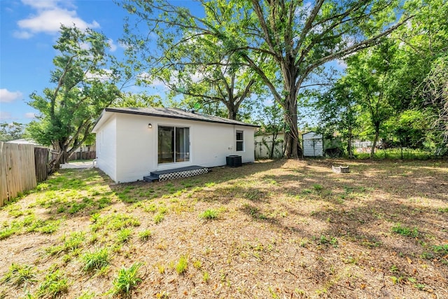 8504 N 17th St, Tampa, FL 33604 - back of property with a fenced backyard, central AC, and stucco siding