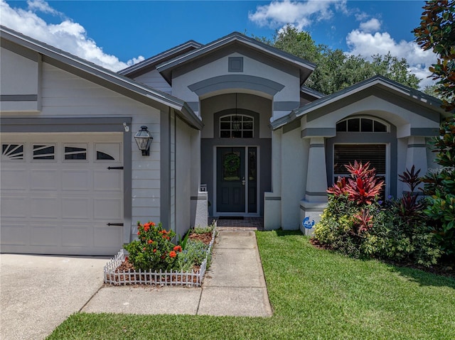 18003 Arbor Crest Dr, Tampa, FL 33647 - property entrance featuring an attached garage, a yard, stucco siding, and driveway