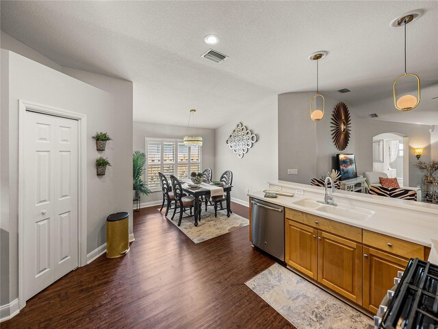 18003 Arbor Crest Dr, Tampa, FL 33647 - kitchen with dishwasher, a sink, dark wood-style floors, arched walkways, and brown cabinets