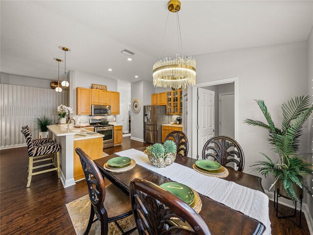 18003 Arbor Crest Dr, Tampa, FL 33647 - dining area with dark wood-type flooring, baseboards, a chandelier, and recessed lighting
