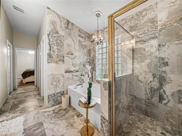 18003 Arbor Crest Dr, Tampa, FL 33647 - full bathroom with a freestanding bath, a marble finish shower, a chandelier, marble finish flooring, and tile walls