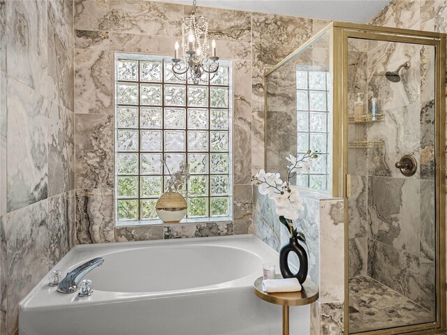18003 Arbor Crest Dr, Tampa, FL 33647 - bathroom featuring a bath, a stall shower, a chandelier, and tile walls