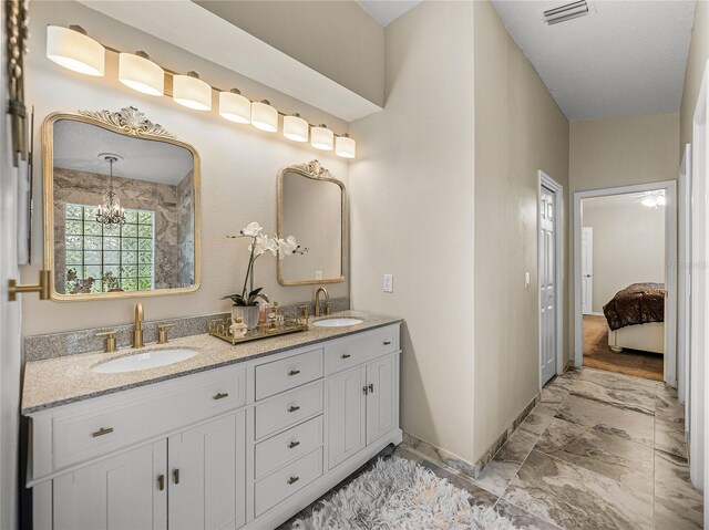 18003 Arbor Crest Dr, Tampa, FL 33647 - full bath featuring marble look tile flooring, double vanity, baseboards, and connected bathroom
