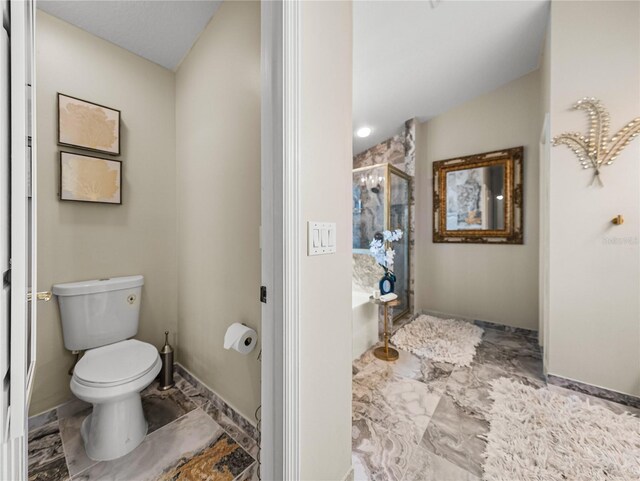 18003 Arbor Crest Dr, Tampa, FL 33647 - full bath with marble finish flooring, a stall shower, toilet, a bath, and baseboards