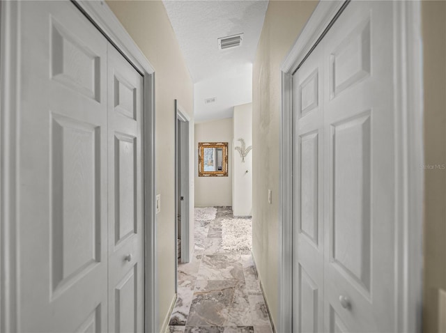 18003 Arbor Crest Dr, Tampa, FL 33647 - hallway featuring light marble finish floors and a textured ceiling