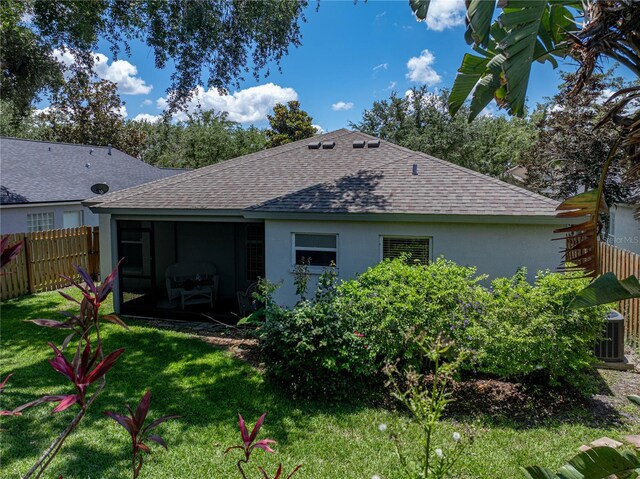 18003 Arbor Crest Dr, Tampa, FL 33647 - back of property featuring roof with shingles, a sunroom, central AC, and stucco siding