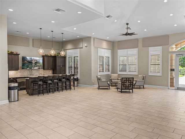 18003 Arbor Crest Dr, Tampa, FL 33647 - kitchen featuring baseboards, open floor plan, recessed lighting, a breakfast bar area, and decorative backsplash