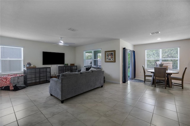 5189 Greenheart Ave, Mount Dora, FL 32757 - living area with light tile patterned floors, ceiling fan, and baseboards