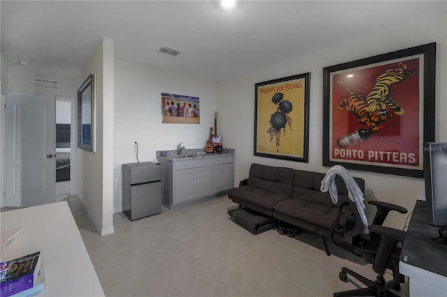 5189 Greenheart Ave, Mount Dora, FL 32757 - living area with baseboards, bar with sink, a desk, and light tile patterned floors