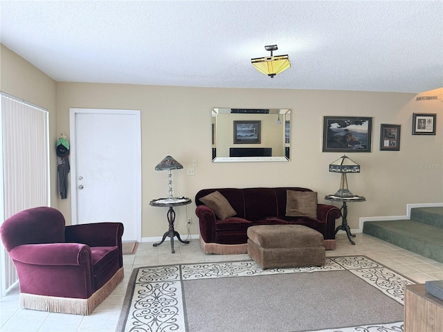 11764 Raintree Dr Unit 0, Temple Terrace, FL 33617 - living room with light tile patterned floors, a textured ceiling, and baseboards